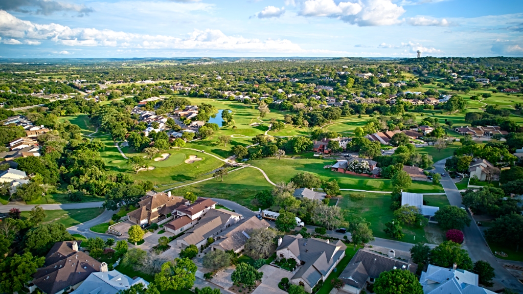 A bird's-eye view of the surroundings of residential buildings and beautiful green fields. Houston, Texas